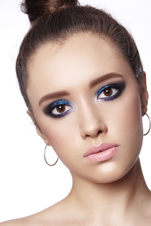 Beautiful Woman with Professional Makeup. Celebrate Style Eye Make-up, Perfect Eyebrows, Shine Skin. Bright Fashion Look.の写真素材