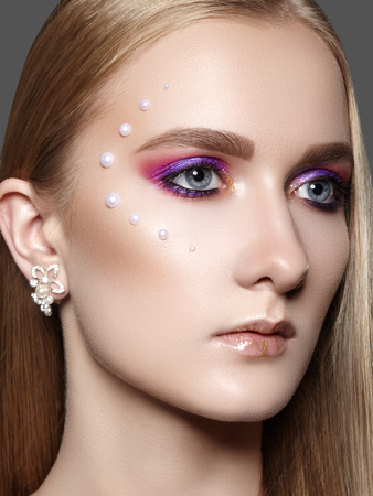 Beautiful Woman with Professional Makeup. Celebrate Style Eye Make-up, Perfect Eyebrows, Shine Skin. Bright Fashion Look.の写真素材