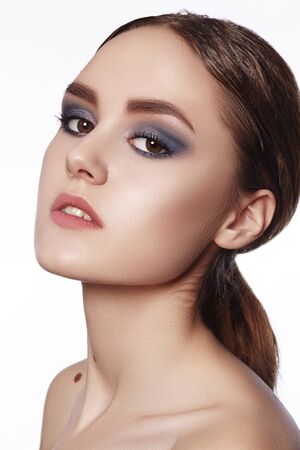Beautiful Woman with Professional Makeup. Celebrate Style Eye Make-up, Perfect Eyebrows, Shine Skin. Bright Fashion Look.の写真素材