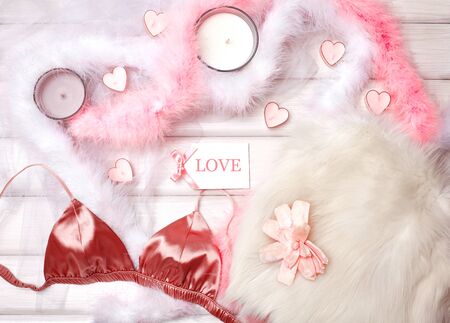 Cozy Winter Flatlay with Heart Shape Candles, Gifts and Warm Knitted Plaid. Pink Still life for St. Valentine's Day. Relax in Weekend for Woman. Hygge Style.の写真素材