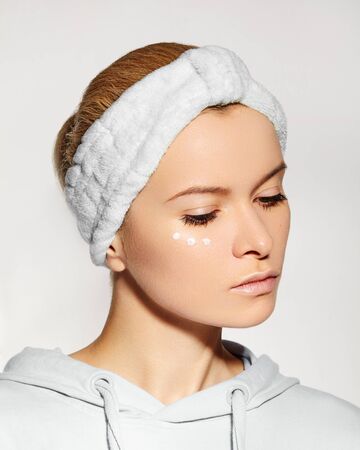 Spa and Wellness. Woman Applying Beauty Eye Cream. Eye Contour Wrinkle Cream or anti-aging Skin Care Moisturizer. Daily Morning Face Care Routine for Woman. Natural Fresh Style with Clean Skinの写真素材