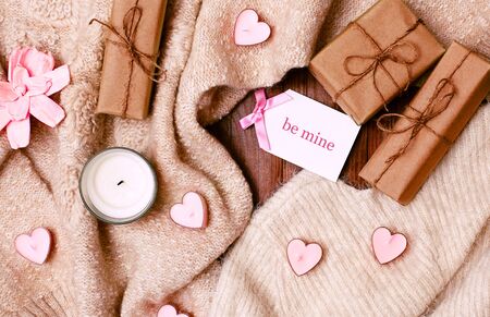Cozy Winter Flatlay with Heart Shape Candles, Gifts and Warm Knitted Plaid. Pink Still life for St. Valentine's Day. Relax in Weekend for Woman. Hygge Style.の写真素材