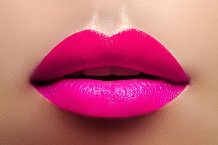 Cosmetics, Makeup and Trends. Magenta Lipstick on Lips. Closeup of Beautiful Female Mouth with Pink Makeup. Beautiful part of Female Faceの写真素材