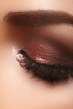 Closeup Macro of Woman Face with Eyes Make-up. Fashion Celebrate Makeup, Glowy Clean Skin, Extra Long Eyelashes.の写真素材