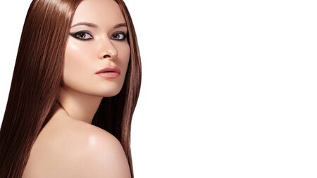 Beautiful Young Woman with Clean Skin, Beautiful Straight Shiny Hair, Fashion Makeup. Glamour Make-up. Portrait Sexy Brunette. Beautiful Smooth Hairstyle with Keratin Treatmentの写真素材