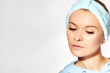 Spa and Wellness. Woman Applying Beauty Eye Cream. Eye Contour Wrinkle Cream or anti-aging Skin Care Moisturizer. Daily Morning Face Care Routine for Woman. Natural Fresh Style with Clean Skinの写真素材