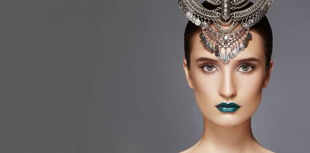 Beautiful Woman with Silver Diadem. Modern Indian Fashion Style. Jewelry Luxury Accessories. Bright Make-up, sexy metallic Lipsの写真素材