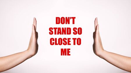Don't Stand So Close to Me. Distancing and Contact-less Greetings. Healthcare Poster with Red Inscription. Two Hands Gesture Limit Social Distance. Public Health Conceptの写真素材