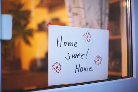 Childs Drawing Phrase Home, sweet home on white card. Handmade Board with Cute Cozy Text. Vintage Lettering House Design. Stay Home, Be Healthyの写真素材