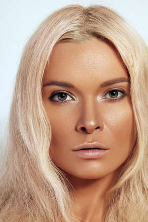 Beautiful close-up portrait of tanned skin woman. Sunburnt girl face with natural boho bronzed make-up. Sexy bohemian beach summer style makeupの写真素材