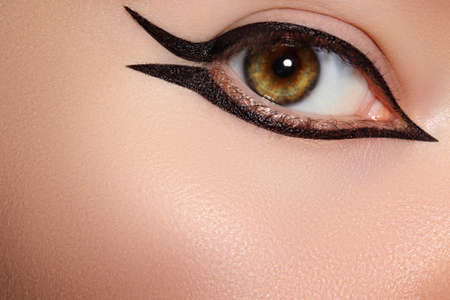 Beautiful macro shot of female eye with classic eyeliner makeup. Perfect shape eye liner. Cosmetics and make-up. Closeup macro shot of fashion liner eyes visageの写真素材