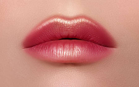 Macro close-up glamor fashion bright red lips make-up with gold glitter. Macro of woman's face part. Sexy lip makeup, luxury visageの写真素材