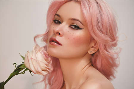 Soft-Girl Style with Trend Pink Flying Hair, Fashion Make-up. Blond Woman Face with Freckles, Blush Rouge, Rose Flowersの写真素材