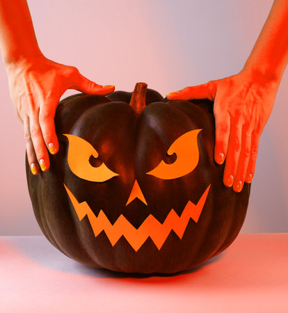 Halloween Pumpkin with Paper Cut Scary Face on a White Background. Jack Halloween. Smile Jack Pumpkinの写真素材