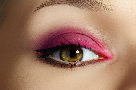 Closeup Macro of Woman Face with Blue Eyes Make-up. Fashion Celebrate Makeup, Glowy Clean Skin, perfect Shapes of Browsの写真素材