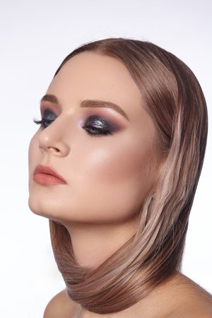 Beautiful Woman with an Fashion Hairstyle and Creative Makeup. Beauty face with trendy Make-upの写真素材
