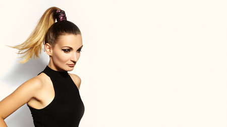 Fashion portrait of beautiful young woman with ponytail hairstyle. Pony tail straight hair, eyeliner makeupの写真素材