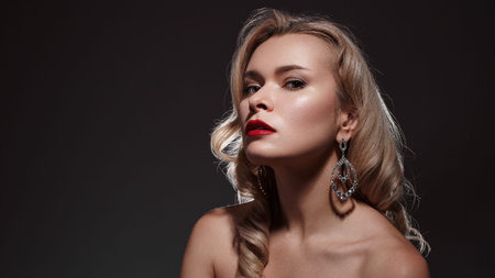 Blonde Caucasian Woman Shoulders Bared Commanding Gaze, Fashion Editorial Styling, Glossy Red Lips,...