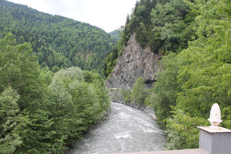 A river and a green meadow in the Caucasus mountainsの写真素材