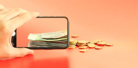 Money paper euro banknotes on the background of a smartphone screen, cents on a red background, the...