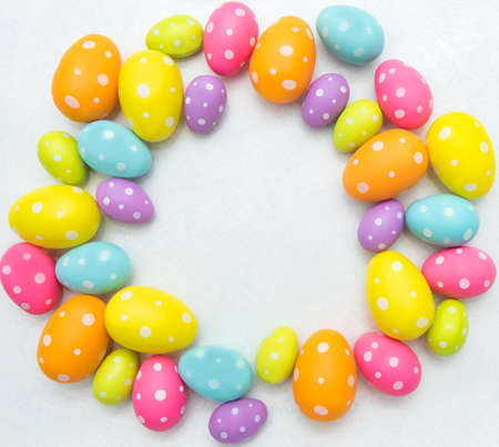Bright Easter eggs on a white background, laid out in a circle