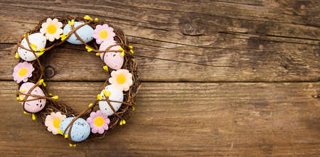 Easter wreath on an old wooden background