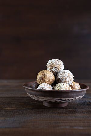 Energy protein balls on a dark wooden background. Healthy, nutritious and delicious snack. Horizontal photo with copy space.の写真素材