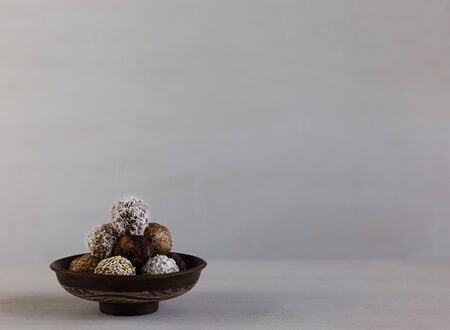 Energy protein balls on a white wooden background. This is a very healthy and delicious product consisting of nuts, dried fruits and peanut paste.の写真素材