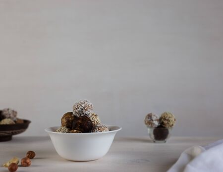 Energy protein balls on a white wooden background. This is a very healthy and delicious product consisting of nuts, dried fruits and peanut paste.の写真素材