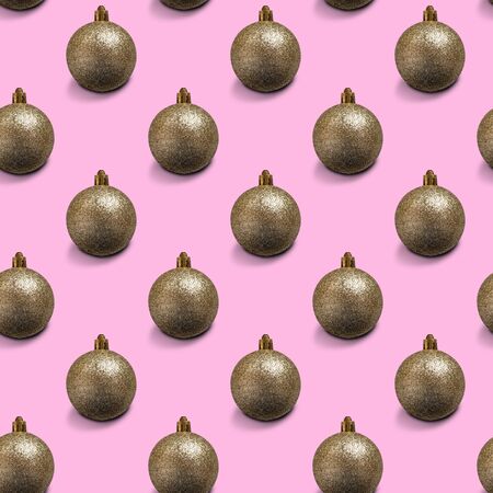Seamless Christmas pattern with shiny Golden balls on pink background.の写真素材