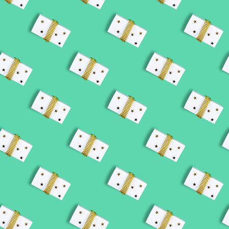 Seamless Christmas pattern with Xmas gift box on mint background. Flat lay.の写真素材