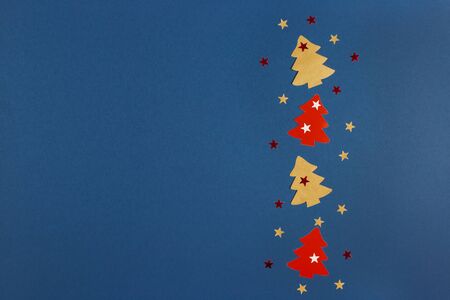 Christmas banner with Xmas tree and stars handmade on blue background with copy space. Flat lay.の写真素材