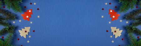 Christmas banner with Xmas tree and stars handmade on blue background with copy space. Flat lay. Top...