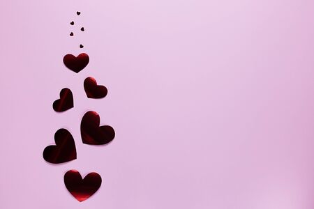Flying red hearts on a pink background. Valentine's day. Holiday of all lovers.の写真素材