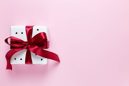 White gift box with hearts on a pink background. Valentine's day. Holiday of all lovers.の写真素材