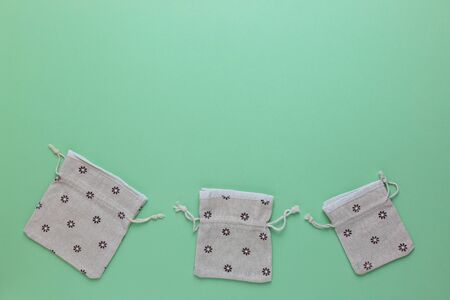 Cotton bags on a green background. Zero waste, plastic free. Sustainable lifestyle concept. Space...