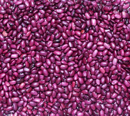 Food background of many grains of dried beans. The texture of the red bean. Close up. Flat lay.
