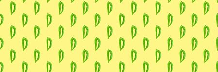 Seamless pattern of green hot chilli peppers on a yellow. Food background, texture. Minimal concept.の写真素材