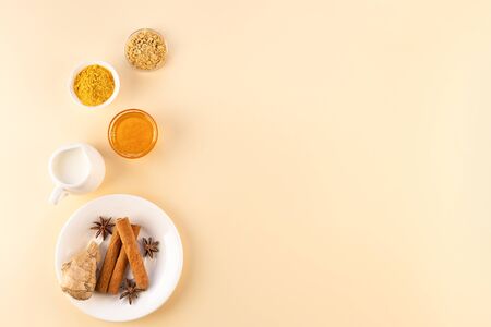 Ingredients for making Golden milk on a beige background. Masala Haldi Doodh. The concept of alternative medicine.の写真素材