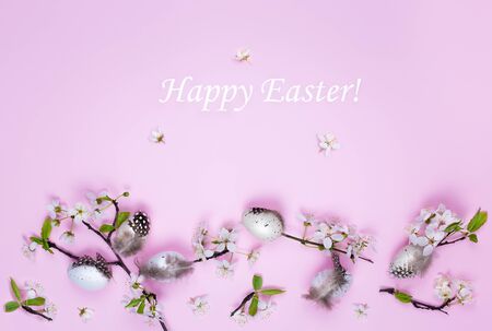 Easter eggs and spring flowers on a pink background with text. Spring concept.の写真素材
