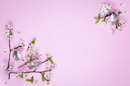 Easter eggs and spring flowers on a pink background with copy space. Spring concept.の写真素材