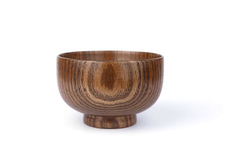 Wooden brown bowl isolated on a white background.の写真素材