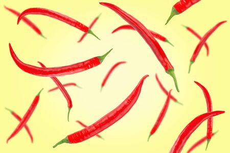 Falling red chilli peppers isolated on a colored background    as package design element and advertising. Flying vegetables. Top view.の写真素材