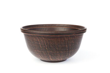 Brown clay bowl isolated on a white background.の写真素材