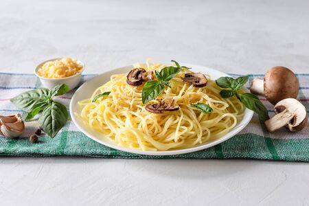 Delicious delicious pasta with mushrooms and Basil on a gray background. Italian food concept. Copy space.の写真素材