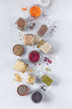 Legumes, seeds and cereals on a gray background. Healthy food. Top view, copy of space.の写真素材