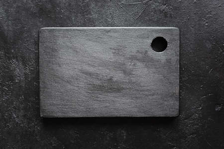 Black cutting Board on a dark background, top view. Empty space for menu or recipe.の写真素材