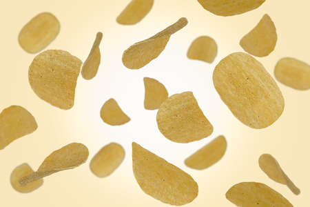 Falling potato chips isolated on a color background with clipping path. Flying food. Unhealthy productsの写真素材