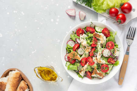Delicious vegetarian Fattoush or Arab salad with pita bread, fresh vegetables on plate. Middle Eastern bread salad.の写真素材