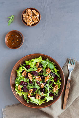 Salad with beets, walnuts, arugula, salad leaves and sesame seeds. Healthy vegetarian food. Top viewの写真素材